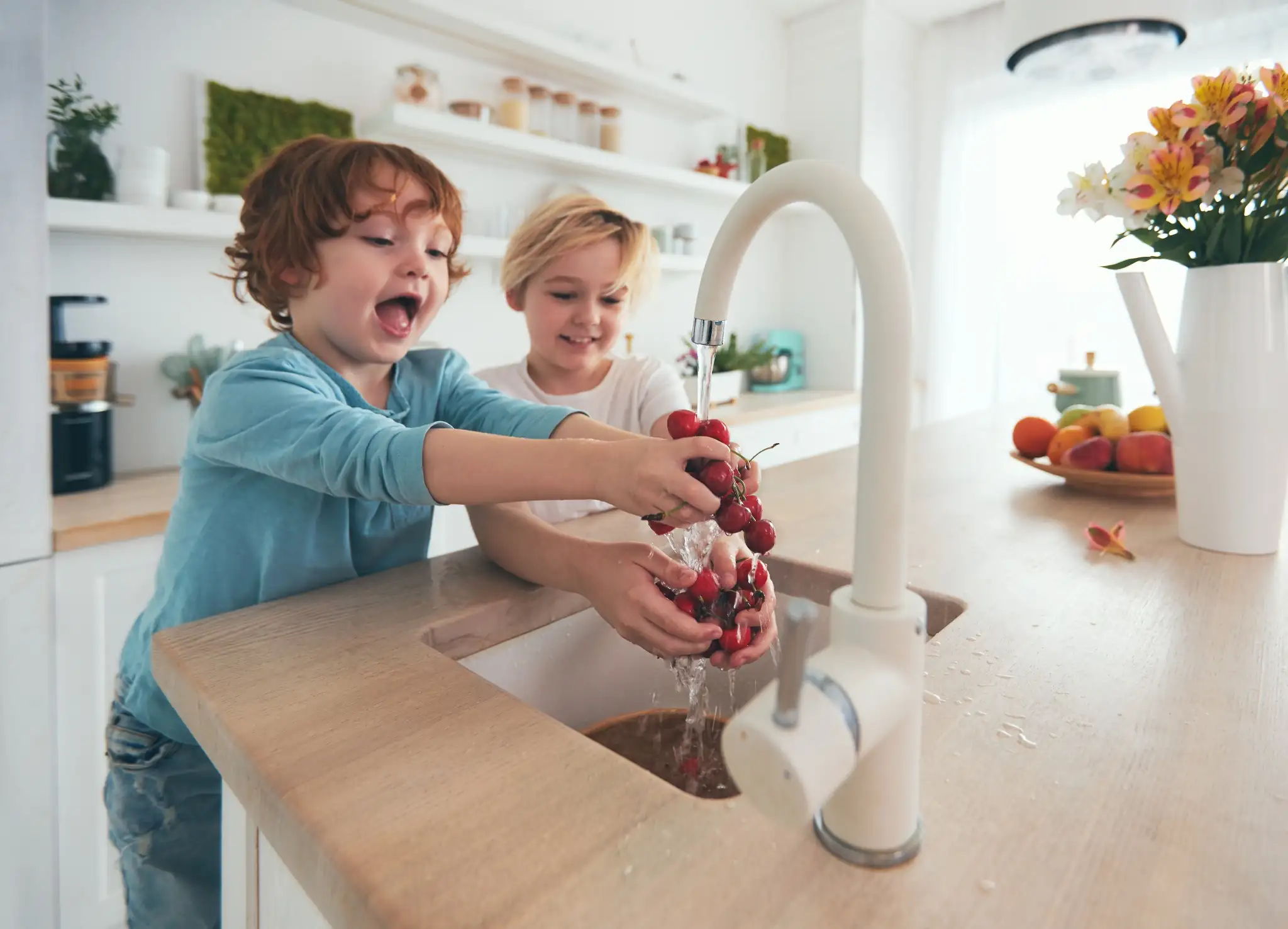 Children washing cherries in clear, clean water